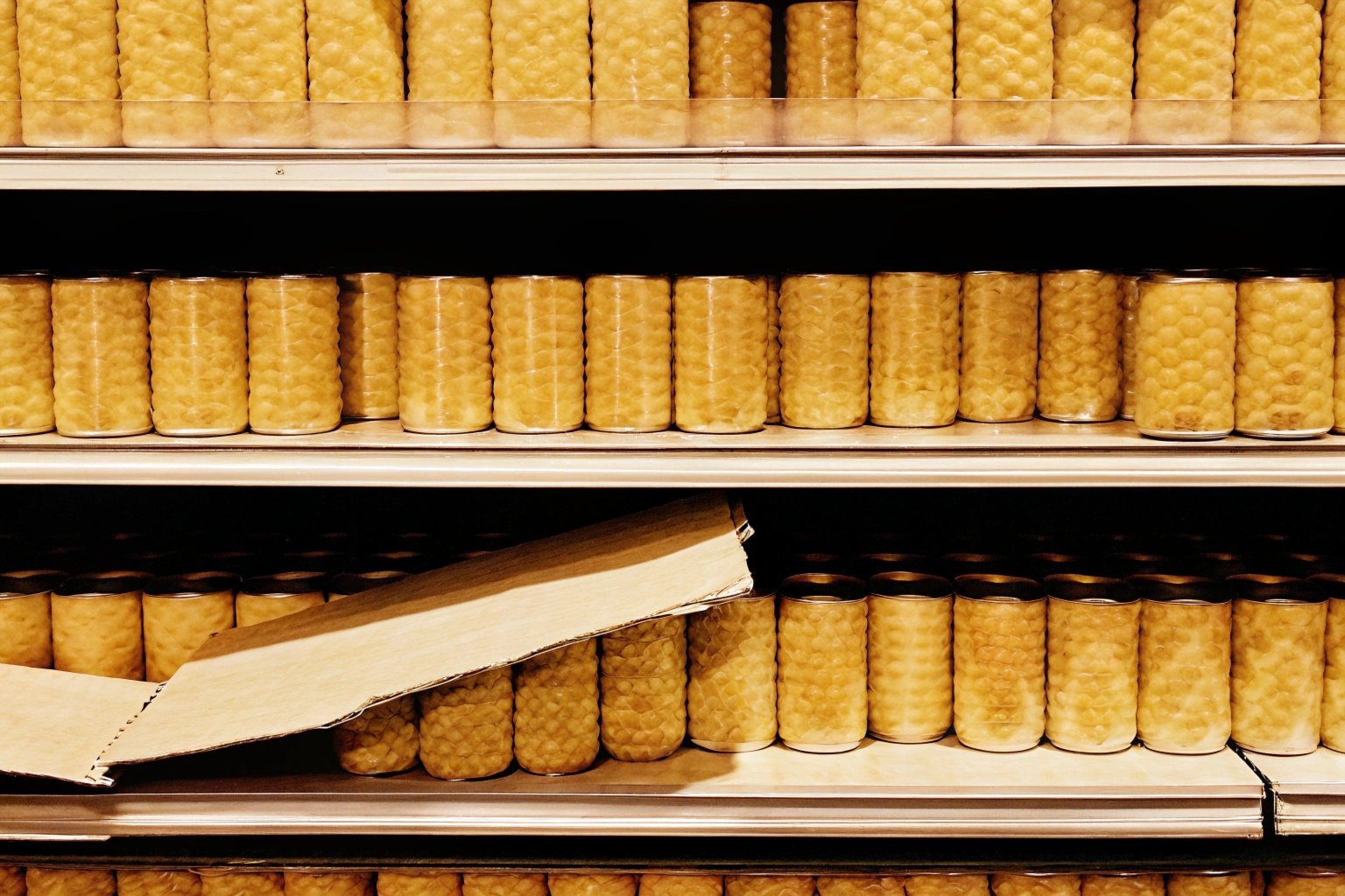 Stack of canned food with one swollen can